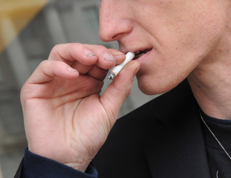 Image: A man smokes a cigarette in Washington, D.C.