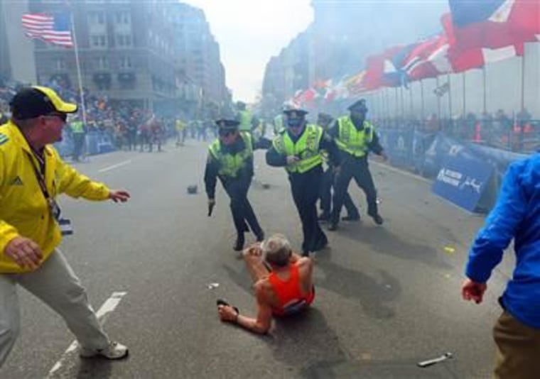 People flee after a bomb explodes at the Boston Marathon on April 22, 2013