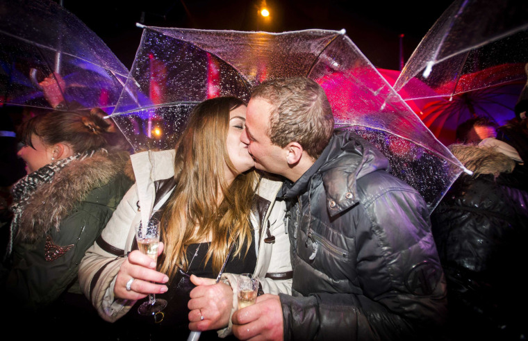 Image: A couple kiss during New Year's Eve celebrations
