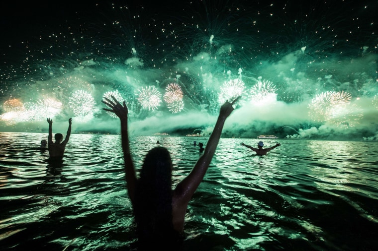 Image: Revelers react to the fireworks on the New Year's celebration at Copacabana beach