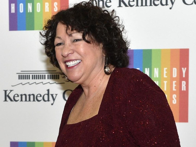 Image: File of U. S. Supreme Court Justice Sotomayor posing for photographers as she arrives at the U.S. State Department for a gala dinner to honor the 2013 Kennedy Center Honorees, in Washington