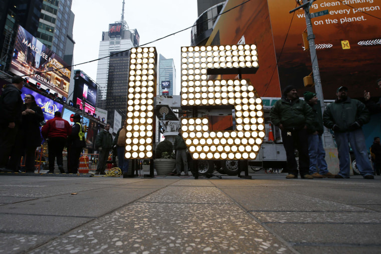 Image: New Year's Eve \"15\" numerals stand lit on the sidewalk after they were unloaded from a truck in Times Square in New York