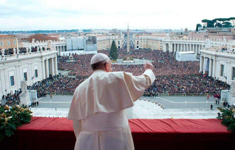Pope Francis waves as he delivers his first "Urbi et Orbi" message from the balcony overlooking St. Peter's Square at the Vatican