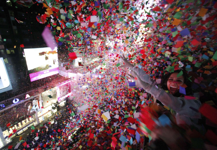Image: Confetti is dropped on revelers at midnight during New Year's Eve celebrations in Times Square in New York