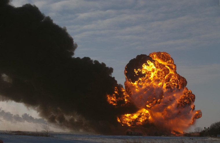 Image: A fireball goes up at the site of an oil train derailment in Casselton, N.D.