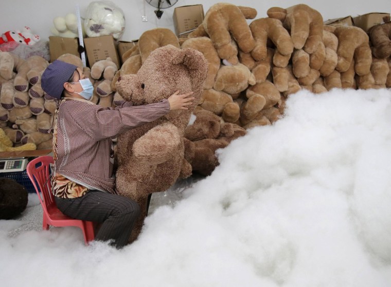 Image: A worker stuffs a toy bear with cotton at a toy factory in Wuhan