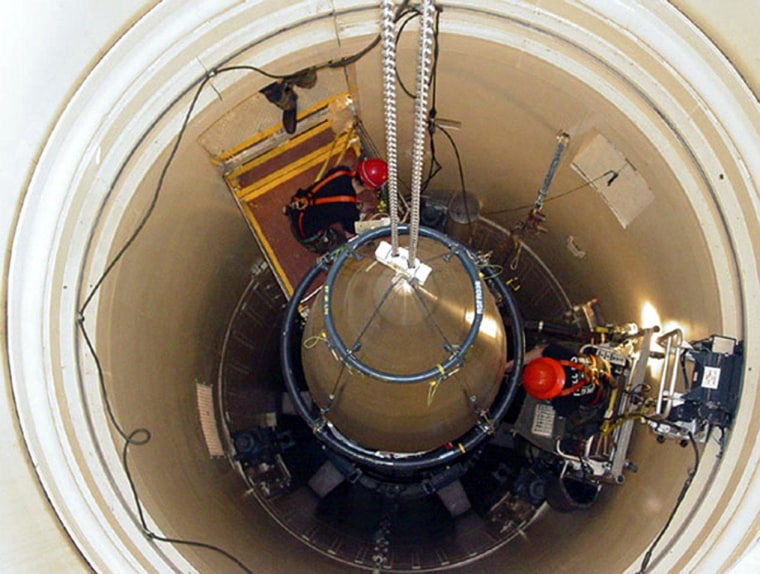 Image: A Malmstrom Air Force Base missile maintenance team removes the upper section of an ICBM at a Montana missile site.