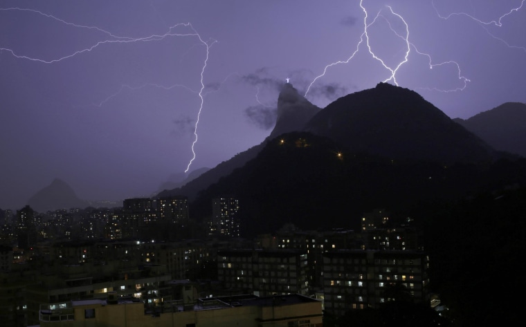 Image: Lightning bolts strike through the sky near Christ the Redeemer statue in Rio de Janeiro
