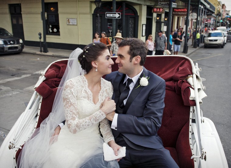 Image: Shannon and Justin Peach riding in a carriage after their wedding in New Orleans