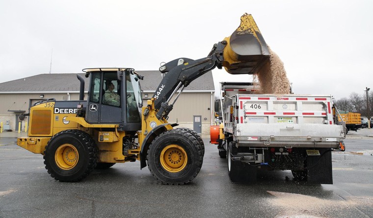 Image: Heavy equipment operator Kelly Von Ellingtton, of Egg Harbor Township, N.J., loads salt onto his truck in Northfield, N.J