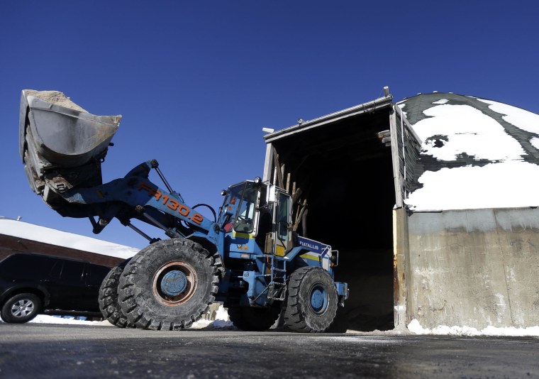 Image: A front loader carries salt out of a mine to be placed on a truck use to salt the streets of Newark, N.J.