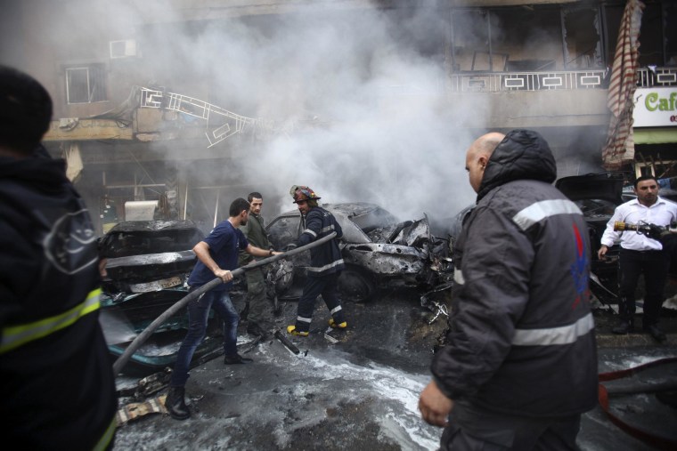 Image: Firefighters extinguish a fire at the site of an explosion in the Haret Hreik area, in the southern suburbs of the Lebanese capital Beirut