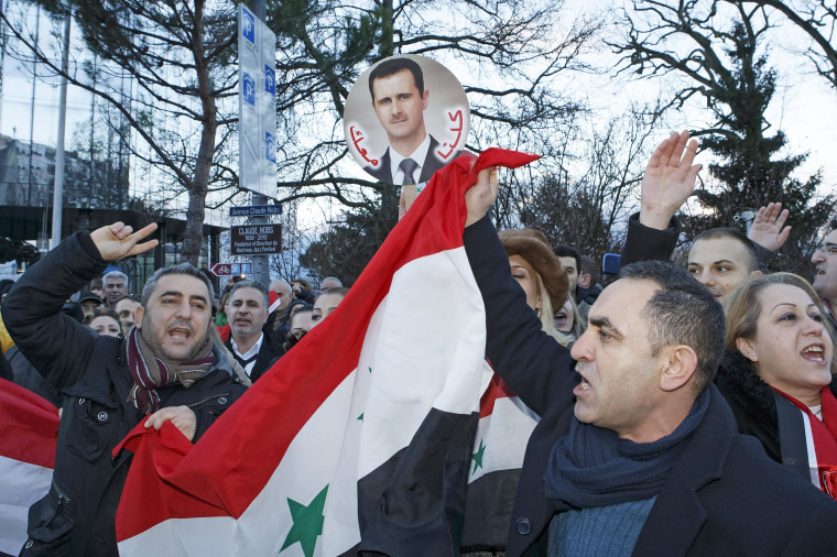 Image: Demonstrators support Syrian President Bashar Assad as they protest Wednesday near the venue of the of peace talks in Montreux, Switzerland.