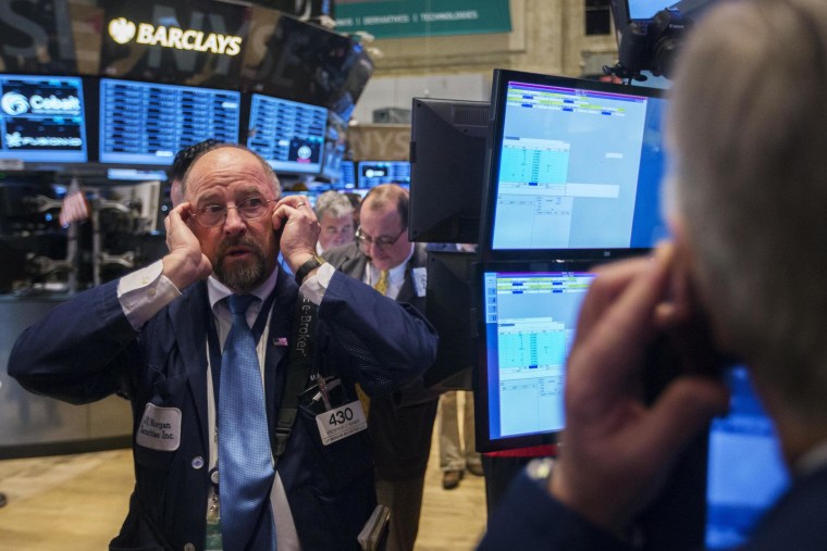 Traders work on the floor of the New York Stock Exchange on Thursday. The Dow ended the day 175 points lower on concerns over global growth.