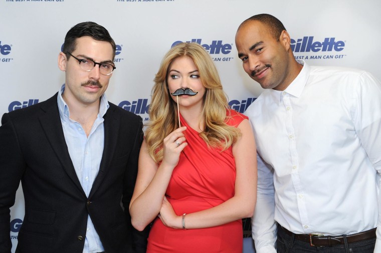 Kate Upton poses with two mustachioed men for a Team Gillette event to support Movember efforts to raise funds and awareness for men's health issues.