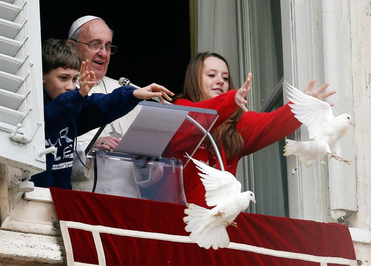 Image: Pope Francis watches as children release doves during the Angelus prayer at the Vatican