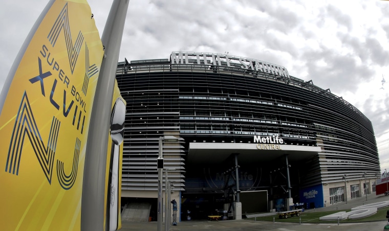 Prices are dropping for tickets to the big game on Sunday. A banner is seen outside MetLife Stadium in East Rutherford, N.J.