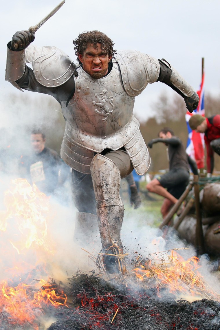 A competitor dressed as a knight runs through a fire during the Tough Guy Challenge on Jan. 26.