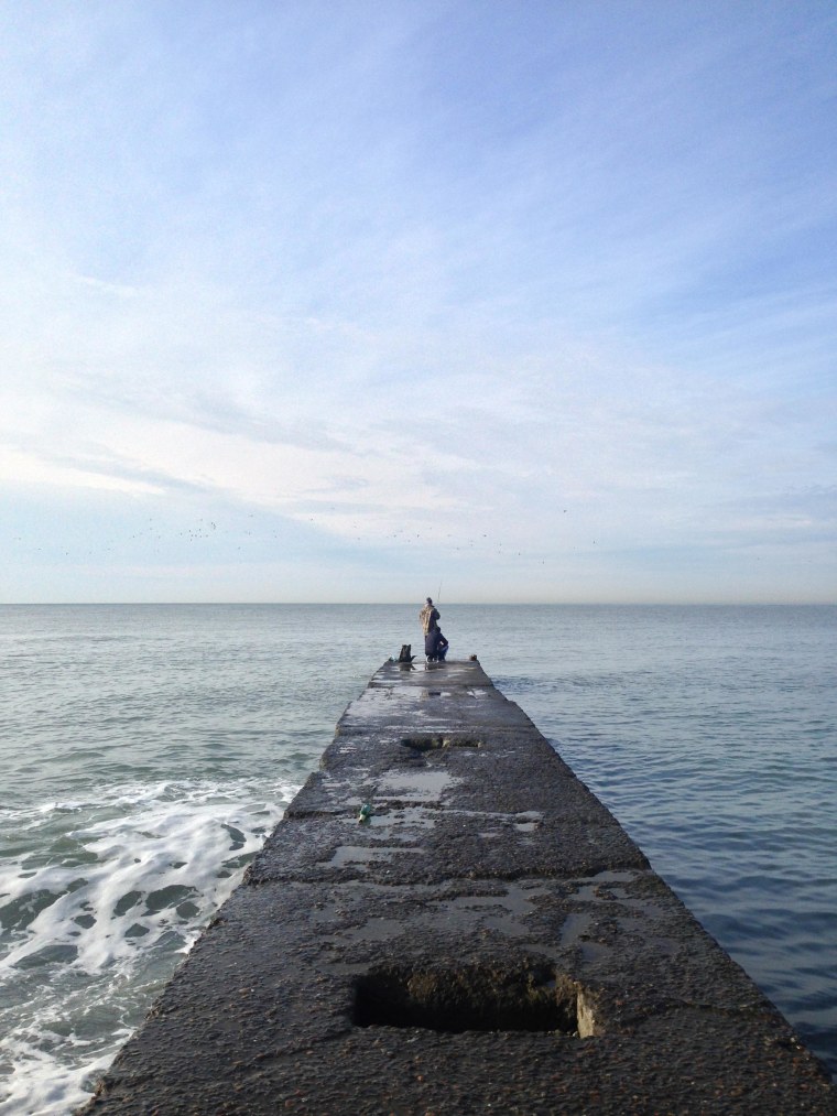 Image: A man fishes in the morning light on the Black Sea in Sochi, Russia.
