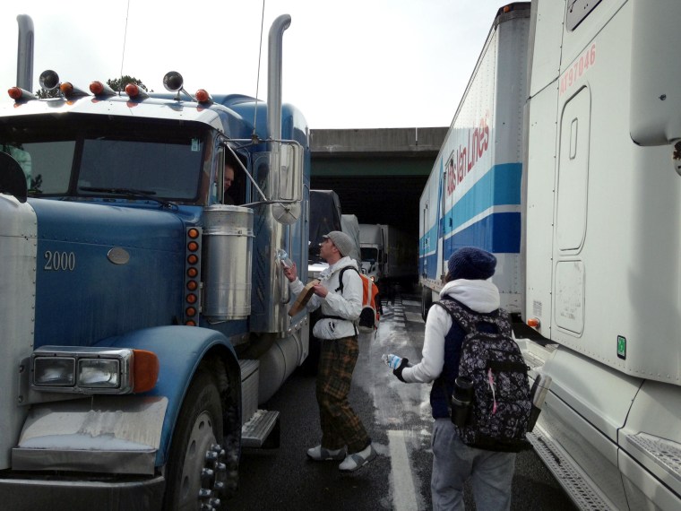 Image: Good samaritans hand out water on I-75 and I-285 near Atlanta.