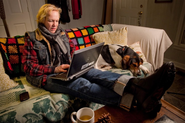 Image: Susie Quick of Midway, Ky., sits bundled up with her dog.