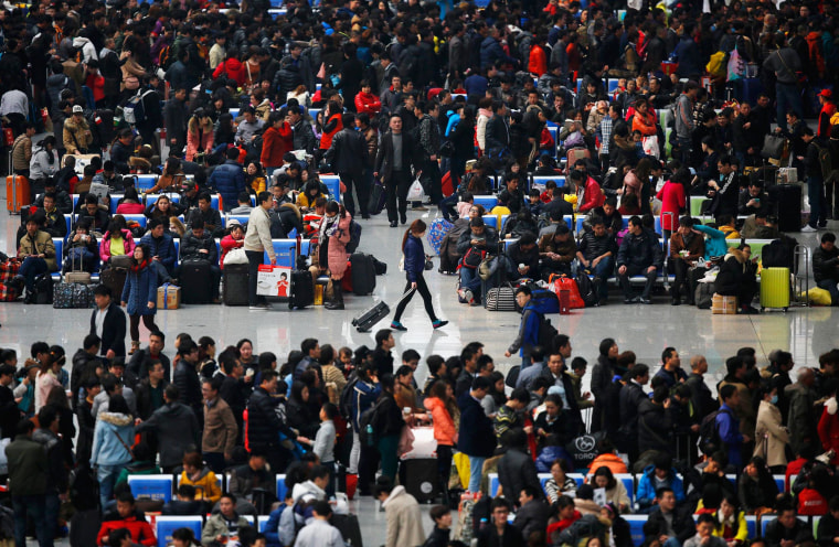 Image: People wait for their trains at Hongqiao train station in Shanghai