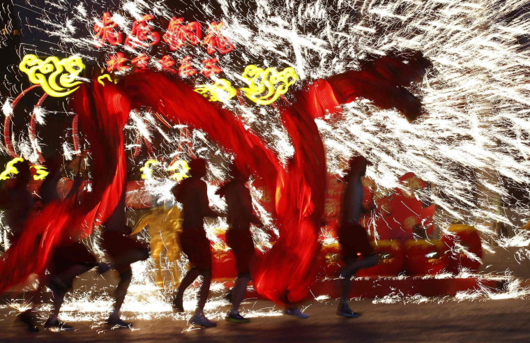 Image: Dancers perform during a folk art performance in Beijing