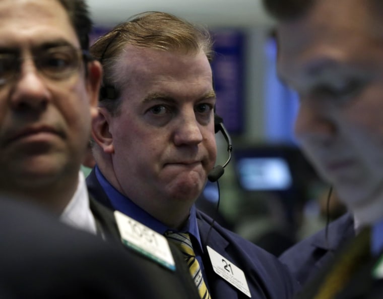 Gloomy view: Traders on the floor of the New York Stock Exchange Friday where the Dow dropped 149 points for its first losing month since August.