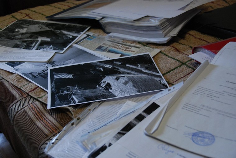 Image: Lumdilla Savelyeva's old house is shown on photos among court and property documents.