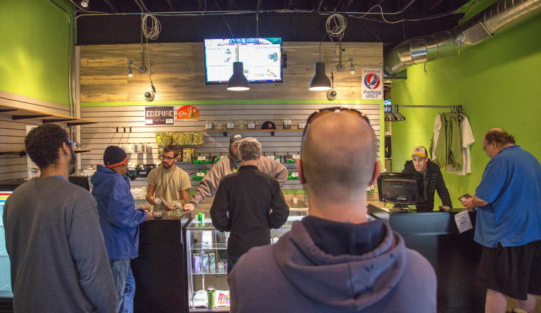 Image: Customers wait in line at the Dank Colorado Dispensary