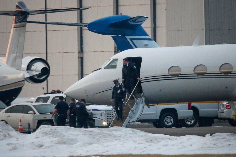 Image: Law enforcement officers leave a plane belonging to Justin Bieber that was detained in New Jersey