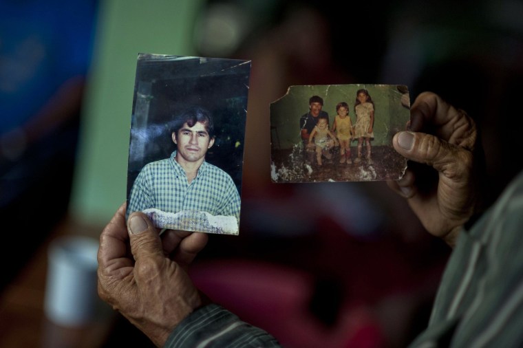 The father of Salvadorean castaway Jose Salvador Alvarenga, Jose Ricardo Orellana, shows pictures of his son, at his house in Garita Palmera, 102 km west of San Salvador on February 4, 2014. Alvarenga claims to have survived 13 months adrift in the Pacific before washing ashore in the Marshall Islands after going on a fishing trip in December 2012 with a teenager who died while they were lost at sea. Alvarenga, who was found at a remote coral atoll last Thursday, was recuperating in a hospital in the Marshall Islands.