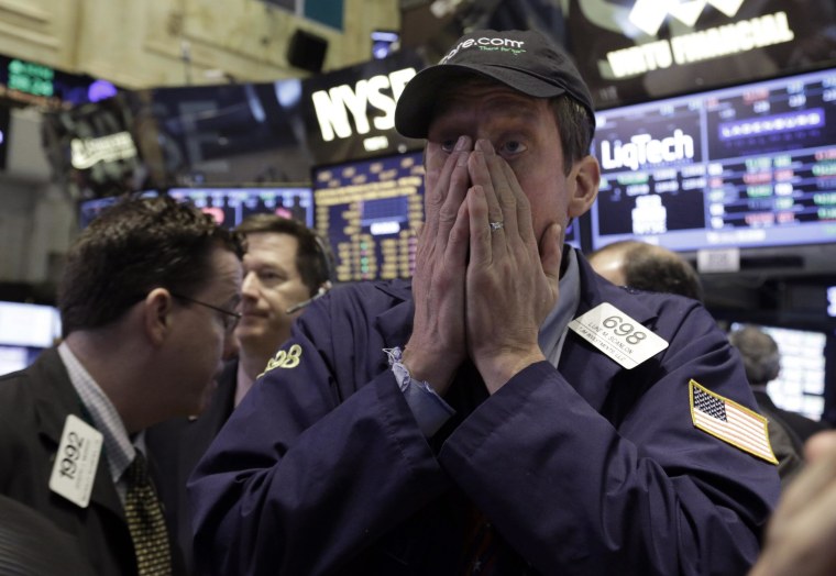 Trader Luke Scanlon works on the floor of the New York Stock Exchange on Wednesday. Stocks edged lower in early trading.