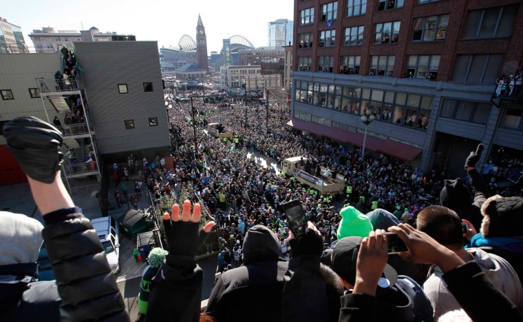 Image: Fans celebrate as the Seahawks make their way through downtown during the NFL team's Super Bowl victory parade in Seattle