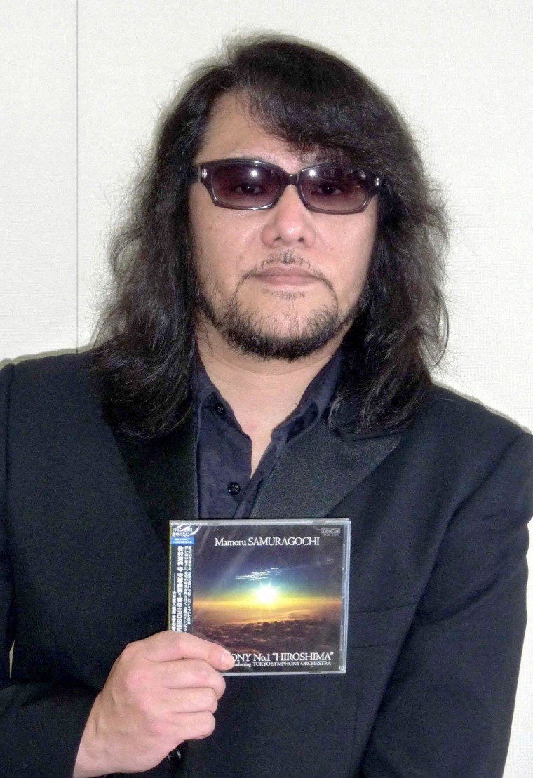 Image: File photo of Mamoru Samuragochi, a famous Japanese classical composer who has been called "Japan's Beethoven", posing with a CD of Symphony No. 1 "Hiroshima"