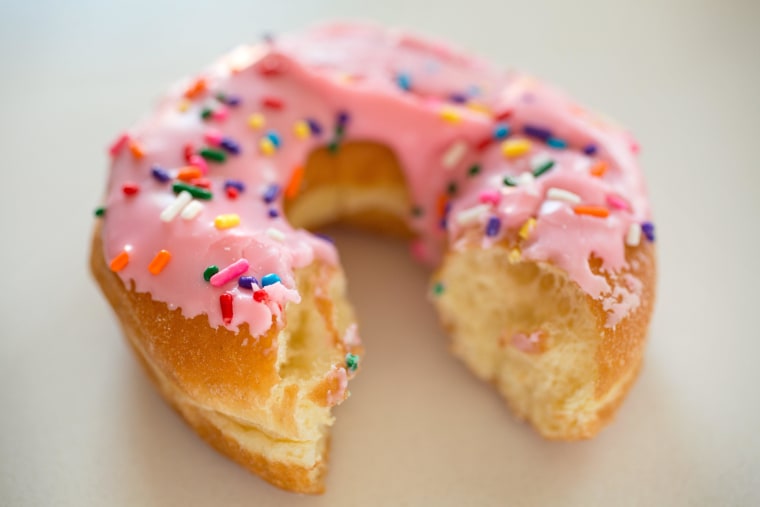 A partially-eaten donut.