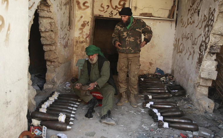 Image: Free Syrian Army fighters prepare mortar shells before launching them toward forces loyal to Syria's President Bashar Assad in Aleppo