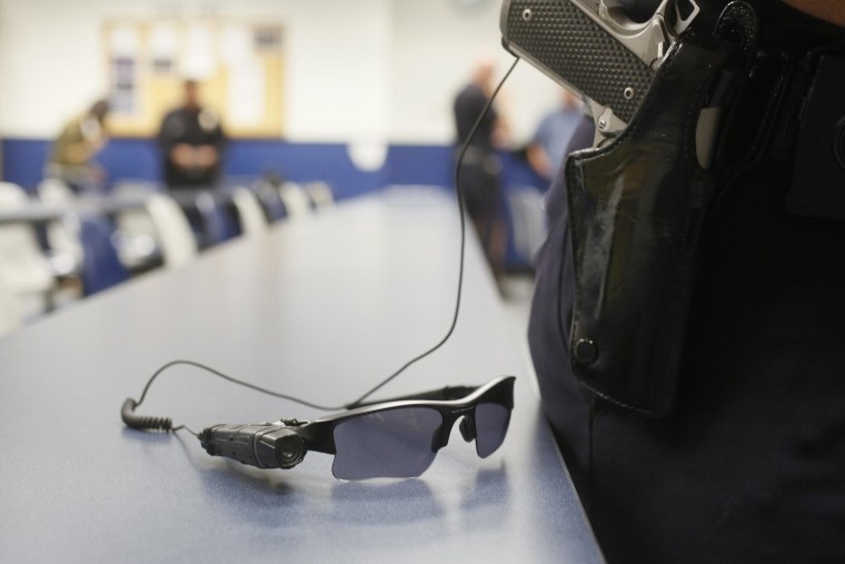 Image: An on-body police video camera is clipped to a Los Angeles Police officers' glasses during a demonstration for media