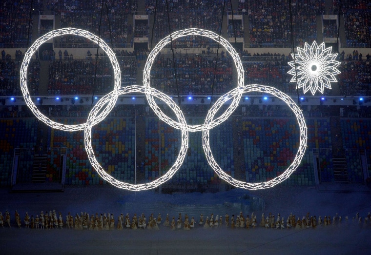 Image: Performers sing as the Olympic rings are presented during the Opening Ceremony of the Sochi Winter Olympics at the Fisht Olympic Stadium