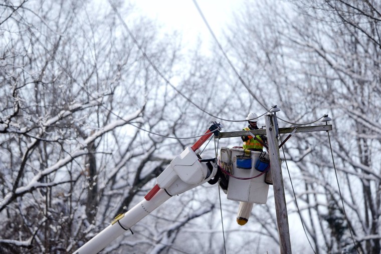 Image: A linesman works to restore electrical power in Downingtown, Pa.