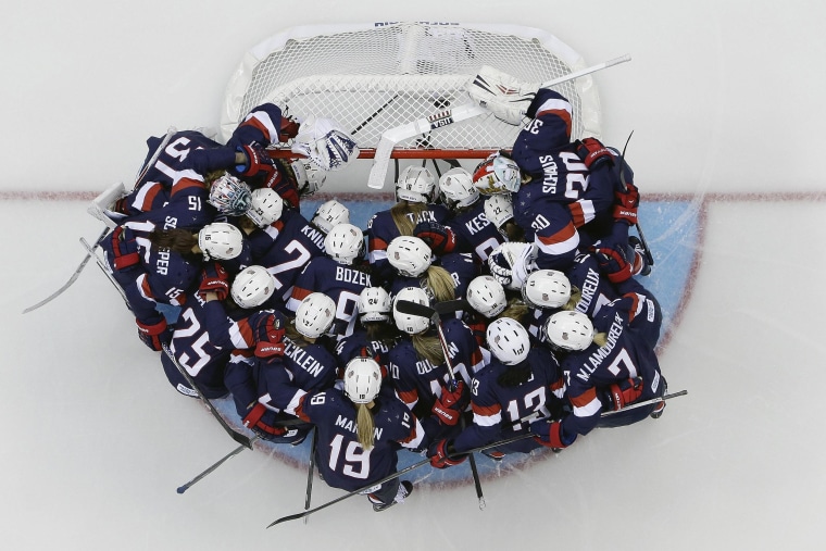 Team USA huddles around the net before the game against Switzerland during the 2014 Winter Olympics women's ice hockey game at Shayba Arena on Feb. 10.