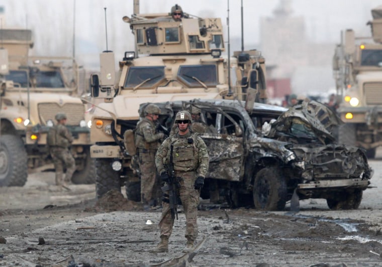Image: U.S. troops stand guard at the site of a suicide car bomb attack in Kabul