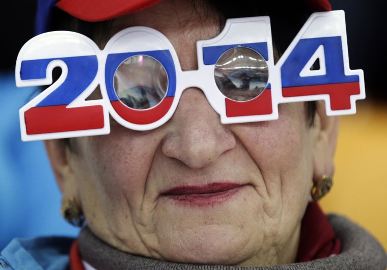 Image: A skating fan wears glasses in the colors of the Russian flag