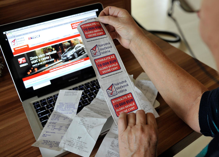 Image: A woman holds store receipts doubling as lottery tickets in Slovakia