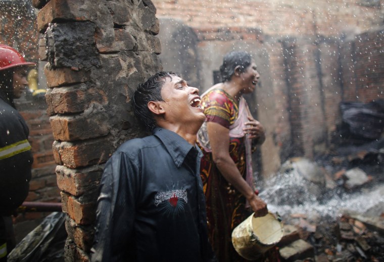 Image: People cry after losing all of their belongings in a fire at a slum at Mirpur in Dhaka