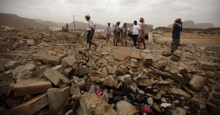 Image: Tribesmen stand on the rubble of a building destroyed by a U.S. drone air strike, that targeted suspected al Qaeda militants in Azan