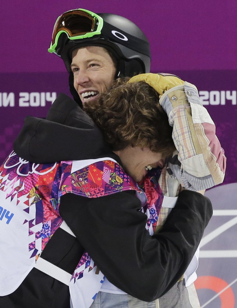 Switzerland's Iouri Podladtchikov, bottom, celebrates with Shaun White of the United States after Podladtchikov won the gold medal in the men's snowboard halfpipe final at the 2014 Winter Olympics.