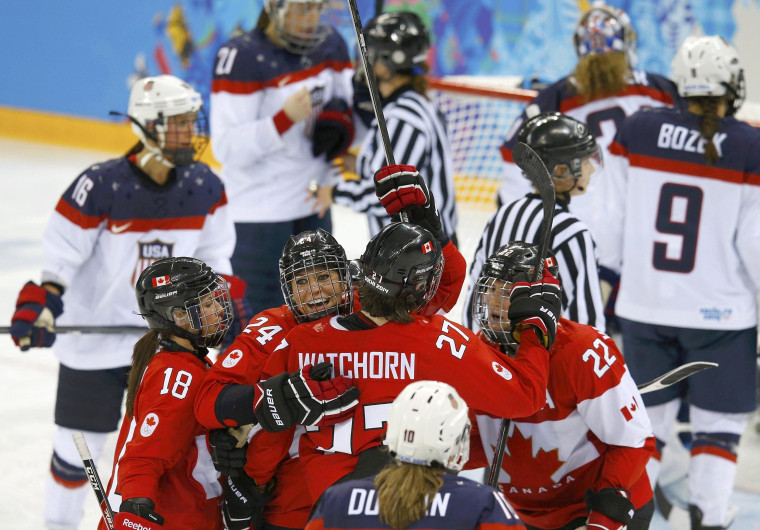Image: Canada's Wickenheiser celebrates her goal with teammates against Team USA's goalie Vetter during the third period of their women's ice hockey game at the 2014 Sochi Winter Olympics