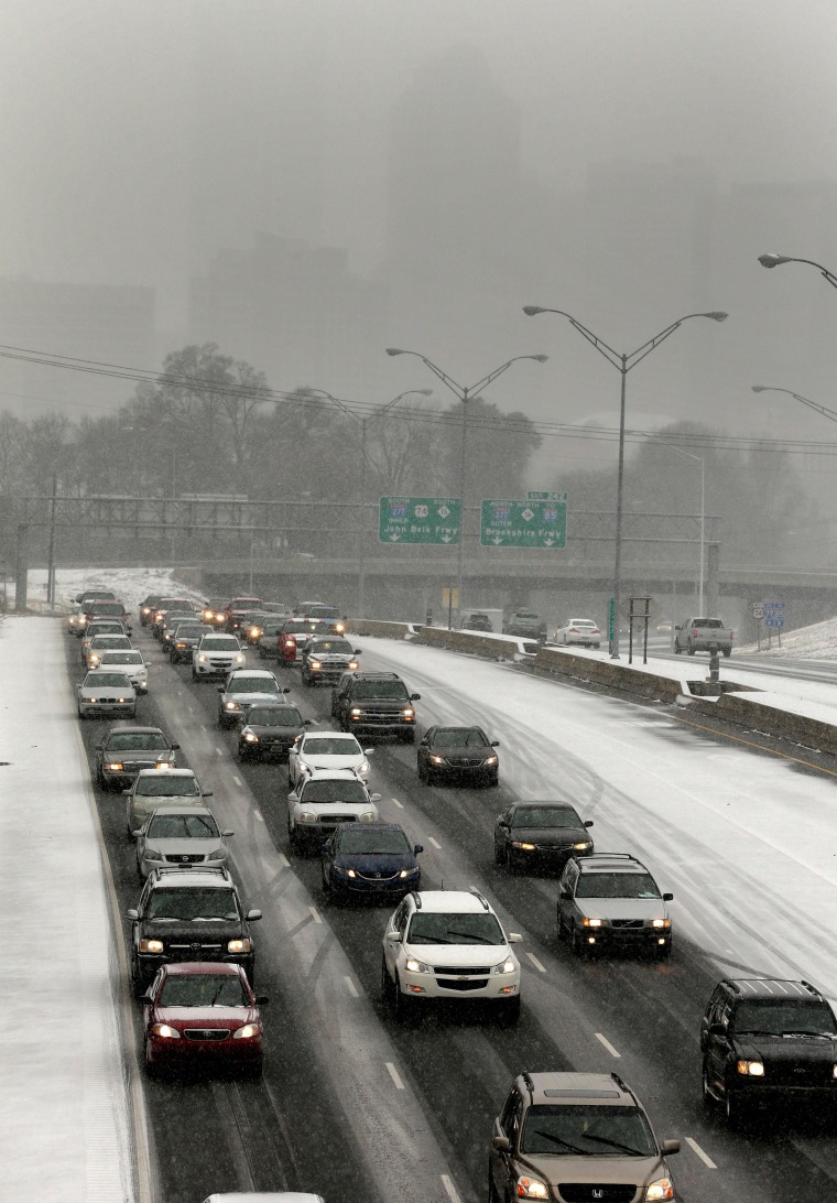Image: Drivers pack the roads as they leave downtown Charlotte, N.C.