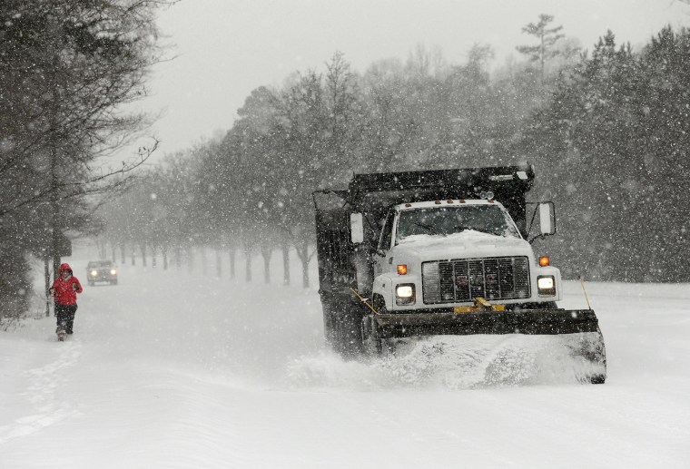 Image: A truck plows a snowy road in Charlotte, N.C.